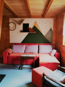 ein Wohnzimmer mit einem roten Sofa und einem Tisch in der Unterkunft Osada Bura Polana in Ujsoły