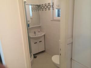 a bathroom with a toilet and a sink at Apartment Vesna in Supetar +39 photos