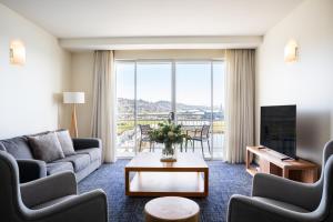 a living room with a couch and a table at Peppers Seaport Hotel in Launceston