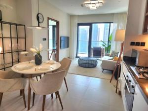 a kitchen and living room with a table and chairs at Vida Dubai Marina & Yacht Club, 1 BR with Marina and Sea View in Dubai