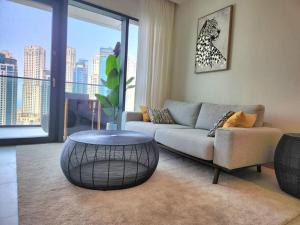 a living room with a couch and a table at Vida Dubai Marina & Yacht Club, 1 BR with Marina and Sea View in Dubai