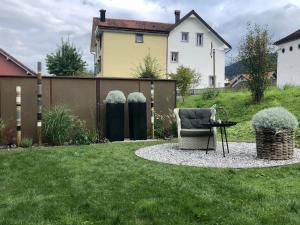 a chair in a yard with a fence at Wohnung Pulverturm in Appenzell