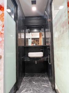 a bathroom with a white sink and a mirror at The Color Kata in Kata Beach
