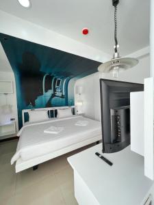 a bedroom with two beds and a fireplace at The Color Kata in Kata Beach