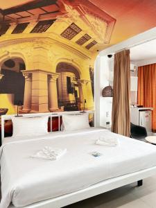 a bedroom with a large white bed in a room at The Color Kata in Kata Beach