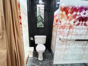a bathroom with a toilet and a shower at The Color Kata in Kata Beach