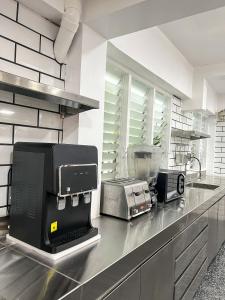 a kitchen with a counter top with a appliance on it at The Color Kata in Kata Beach