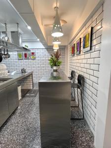 a kitchen with a counter in the middle of a room at The Color Kata in Kata Beach