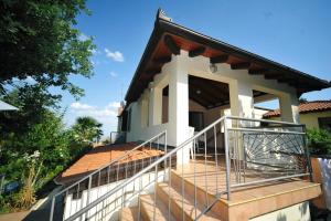 a house with a staircase in front of it at Rooms Novaković in Opatija