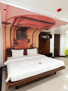 a bedroom with a large bed with a red ceiling at The Color Kata in Kata Beach