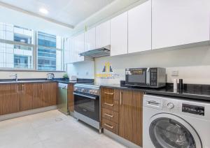 A kitchen or kitchenette at Two Bedroom Apartment in Dubai Marina Hosted by Desert City Stays