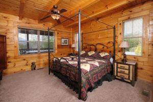 a bedroom with a bed in a log cabin at Hemlock Ridge 1713 in Gatlinburg