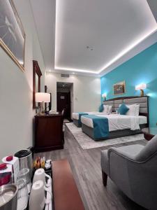 a hotel room with a large bed and a couch at Howard Johnson Bur Dubai in Dubai