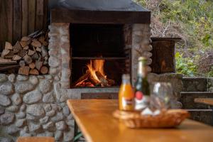 a brick fireplace with a table with a fire place at Horský Hotel Totem in Jarabá