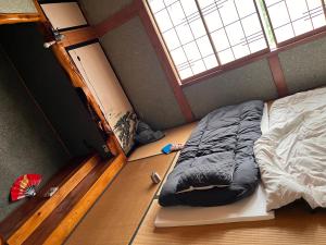 Una cama o camas en una habitación de 信州上田 定宿