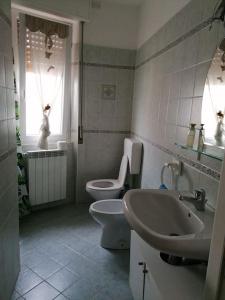 a bathroom with a sink and a toilet and a window at Albisola, a 50 m dal mare in Albisola Superiore
