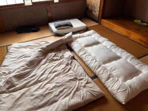 Una cama o camas en una habitación de 信州上田 定宿