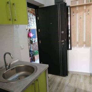 a kitchen with a sink and a large refrigerator at Apartments Center Sarajevo in Sarajevo