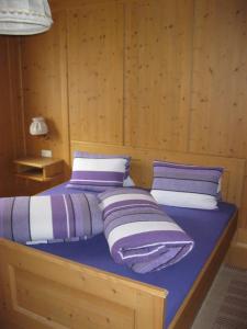 a bed with two pillows on it in a room at Ferienwohnungen Steidl in Innervillgraten