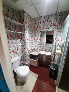 a bathroom with a toilet and a sink at 1809 Sunvida Tower Condo across SM City Cebu in Cebu City +14 photos