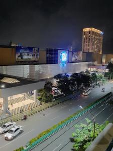 a view of a city at night with cars on the street at 1809 Sunvida Tower Condo across SM City Cebu in Cebu City