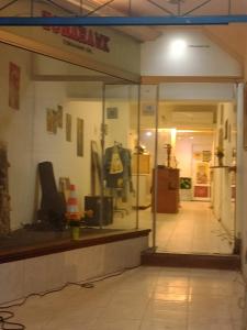 a store front with a display window in a building at The juannas hostal y bistro cultural in Rivera