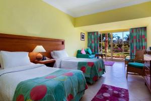 a hotel room with two beds and a balcony at TIME Coral Nuweiba Resort in Nuweiba