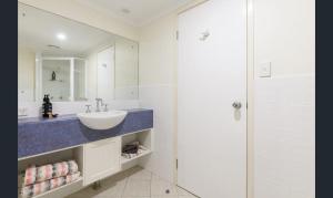 a white bathroom with a sink and a shower at Charming 1 bedroom Apt - Close to Town & Beach in Port Douglas +20 photos