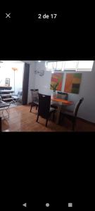 a living room with chairs and a table and a dining room at Apartamento completo en San Borja in Lima