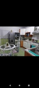 a kitchen with a sink and a table in it at Apartamento completo en San Borja in Lima