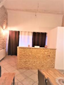 a dining room with a wooden counter and a table at Le Cocoon avec parking gratuit in Cuisery +5 photos