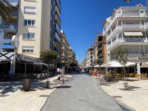 an empty street in a city with buildings at Apartamento cerca de la playa, Torre Del Mar in Torre del Mar