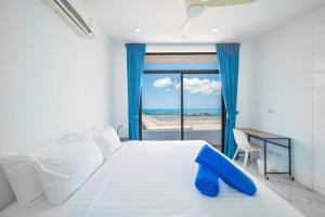 a bedroom with a bed with a view of the ocean at Nastha Villa 3 bedrooms in Koh Samui 