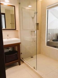 a bathroom with a shower and a sink at Issara Boutique Winery Hotel in Muaklek