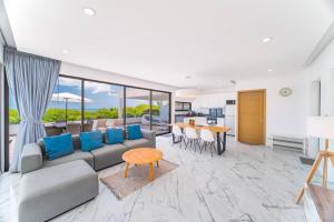 a living room with a couch and a table at Nastha Villa 3 bedrooms in Koh Samui 