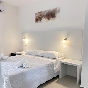 Postel nebo postele na pokoji v ubytování Longevity Hotel
