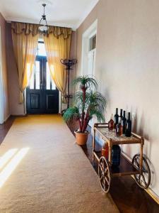 a room with a cart with wine bottles on it at Guest House Adigeni in Adigeni