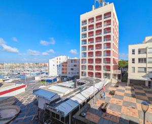 a large building with a marina in a city at Studio Pop plein Centre-Port - ménage, linge inclus in Cap d'Agde