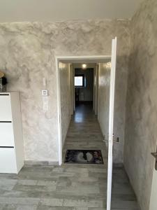 a hallway with a hallway leading to a room with a hallway at appartement de charme proche de Moissac in Labastide-du-Temple +3 photos