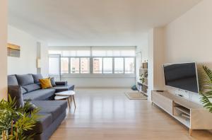sala de estar con sofá y TV en Apartamento frente al mar TORRES DE PLAYAMAR, en Torremolinos