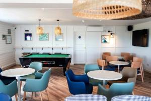 a pool table in a room with tables and chairs at Haven Kent Coast Allhallows 3 bed in Allhallows