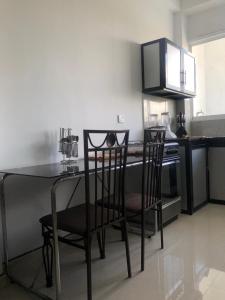 a kitchen with a table and chairs and a stove at Randi Apartments B&B in Boralesgamuwa