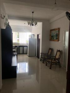 a large living room with chairs and a refrigerator at Randi Apartments B&B in Boralesgamuwa