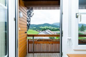 a door to a balcony with a view of the mountains at S'Matt 3 in Lingenau
