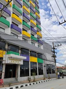 a building with colorful windows on the side of it at INTERTOWER HOTEL (SHA) in Sungai Kolok