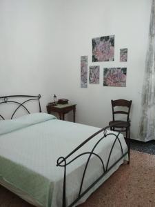 ein Schlafzimmer mit einem Bett und einem Stuhl in der Unterkunft DA GINA in Chiavari