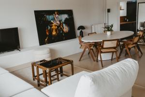 - un salon avec un canapé blanc et une table dans l'établissement Maas Suites - The River House, Maastricht - Lanaken, à Lanaken