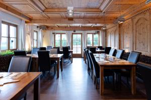 a dining room with wooden tables and chairs at S'Matt 3 in Lingenau