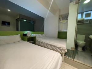 Voodi või voodid majutusasutuse 珀依旅馆 Pop E INN toas