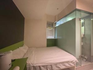 Voodi või voodid majutusasutuse 珀依旅馆 Pop E INN toas
